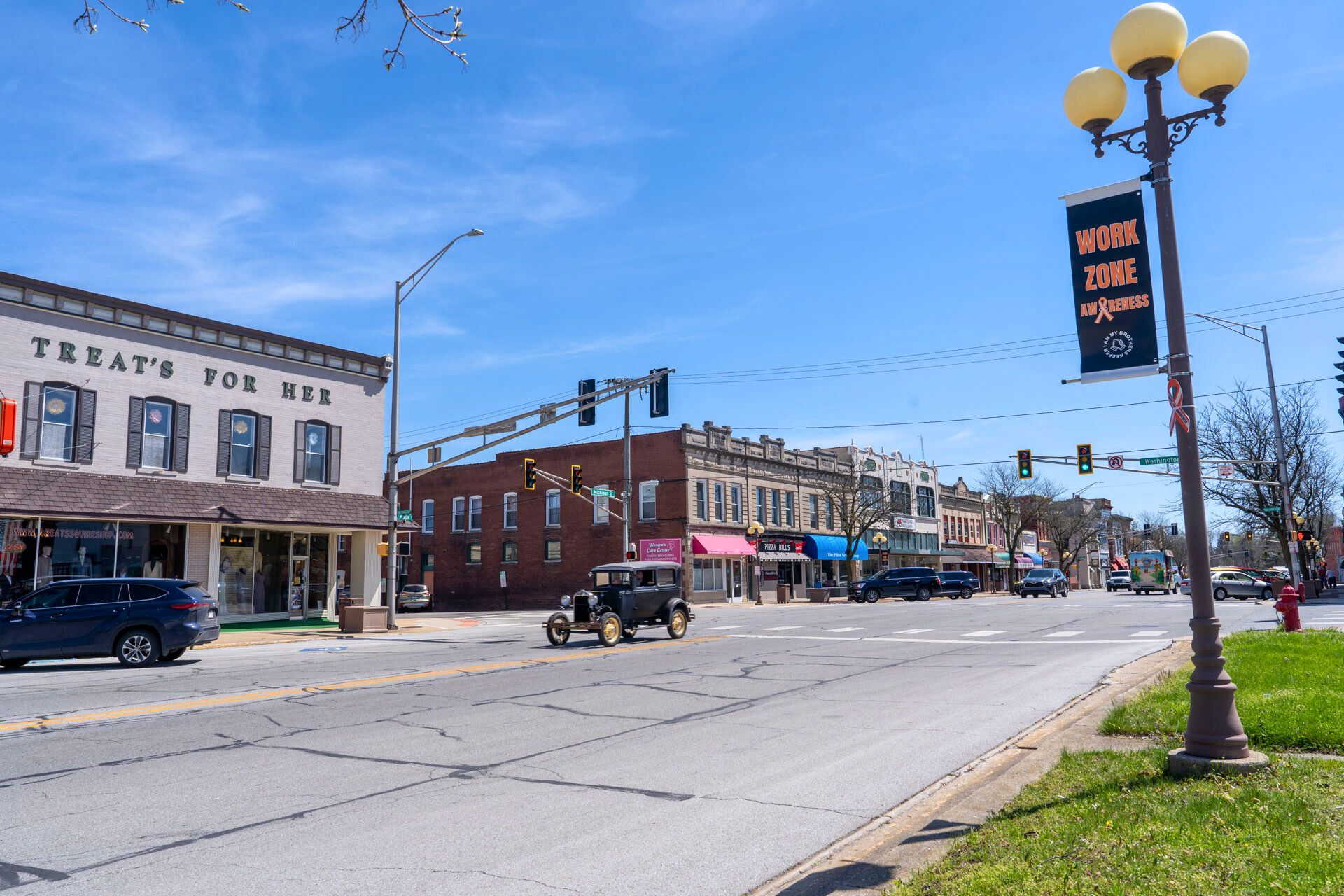 downtown plymouth indiana city street with classic car driving down road